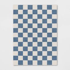 a blue and white checkered rug on a wall