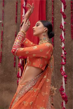 Pakistani Raw Silk Orange Lehenga Choli Dress is tangerine Raw Silk Lehenga is encrusted with pearls, Red Kora, Sitara, and naqshi in gold. It is paired up with a halter-neck choli and tangerine organza dupatta with gorgeous embroidered borders. Choli: With pure fabric heavily laden with sequins, Sitara, naqshi, and the perfect blend of traditional flamboyance and modern style in design, you need to look no further for the perfect look for your special day. Pair this traditionally chic choli wit Golden Dupatta, Orange Lehenga, Choli Dress, Raw Silk Lehenga, Resham Work, Raw Silk Fabric, Neckline Designs, Silk Lehenga, Organza Dupatta