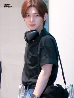 a young man with an inflatable cell phone on his shoulder