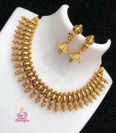 Exquisite Gold-Plated Necklace and Earrings Set. Expertly crafted to reflect the timeless beauty of antique temple jewelry, this set is an impeccable choice for brides and a majestic addition to any ethnic ensemble. The matching earrings, shaped in a classic triangular temple motif, complement the necklace and complete the look with grace. Whether it's for a wedding, a special festive occasion, or to add a touch of opulence to your daily wear, this set is designed to captivate and charm. Temple Jewelry, Wedding Jewelry Set, Kundan Necklaces, Wedding Bridal Jewellery, Necklace And Earrings Set, Cz Jewelry, Temple Jewellery, American Diamond, Traditional Indian