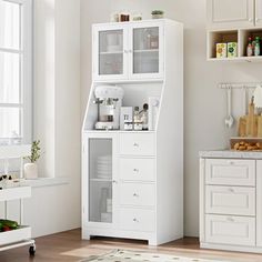 a kitchen with white cupboards and appliances in the corner next to a counter top