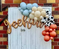 there is a sign that says yeehur with balloons