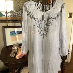 Great Looking Top Can Be Worn Off The Shoulders. Super Versatile As A Top, Beach Cover-Up, Or Short Dress For The Summer. Has Two Toned Fabrication White And Light Gray White Casual Tunic With Floral Embroidery, Embroidered White Tops For Beach Season, Casual Embroidered Tunic For Vacation, Casual Embroidered White Tunic, Casual White Embroidered Tunic, Casual Beach Tunic With Floral Embroidery, Long Sleeve Top With Embroidered Neckline For Beach, Long Sleeve Tops With Embroidered Neckline For Beach, Casual Embroidered Summer Tunic