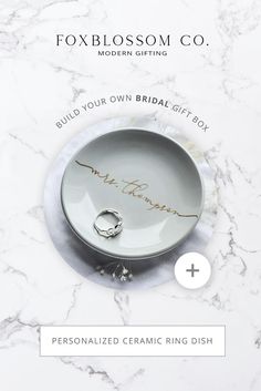 the personalized ceramic ring dish is shown on a marble background with text that reads,'build your own bridal gift box '