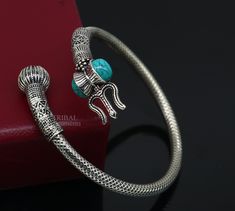 "925 sterling silver fabulous unisex vintage antique design bahubali lord shiva trident trishool with Damaroo bangle bracelet kada .Excellent handmade design open face Turquoise stone kada. Easily wearable by twisting it due to open face. amazing tribal jewelry from Rajasthan india. Metal-925 Sterling silver. Metal purity-92.5%. Brad-traditional-jewellery, Item type-Bracelet/ kada. Width of kada- 5 mm (0.5 centimeter) Size-2.375\" or 2-6 cm ,Easily wearable by twisting the bangle(see picture) In Silver Openable Temple Jewelry, Adjustable Silver Jewelry For Rituals, Silver Openable Bangle Jewelry, Openable Silver Bangle Jewelry, Temple Jewelry Bracelet With Oxidized Finish, Oxidized Temple Jewelry Bracelet, Temple Jewelry Oxidized Bracelet, Silver Openable Bracelets As A Gift, Silver Openable Bracelets For Gift