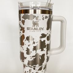 a stainless steel travel mug with brown and white spots