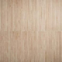 a wooden wall with vertical lines painted on the wood paneling in shades of light brown