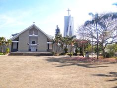 a church with palm trees in front of it