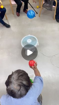 a young boy is playing with an object