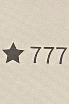 the number 777 is written in black on a white background with a star at the bottom