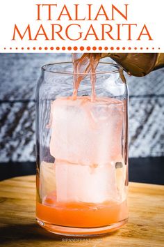 someone pouring orange juice into a glass with ice cubes in it and text overlay that reads how to make italian margarita