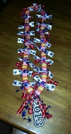 a wooden table topped with lots of red, white and blue ribbon streamers that spell out the number 35