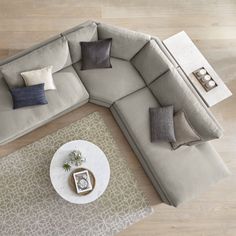 an overhead view of a living room with couches and coffee table on the floor