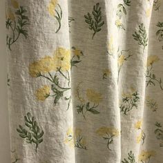 yellow flowers on white fabric with green leaves