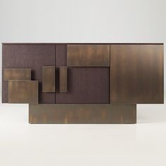 a brown cabinet with square and rectangle shapes on it's sides, against a white background