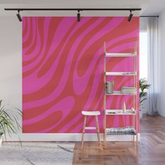 a pink and white wall mural in a living room with a ladder leaning against the wall