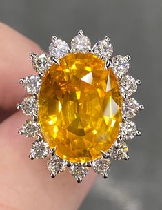 ALL THESE PHOTOS WERE TAKEN WITH AN ORDINARY IPHONE & HAVE NOT BEEN EDITED OR ENHANCED IN ANY WAY.  Up for Sale is a Phenomenal Large Natural Vivid Yellow Sapphire & Diamond Halo Ring in Solid Platinum. This Ring was made by us Here in New York City & is of the Finest Quality. The Face of this ring (sapphire & halo together) measures approx 25 x 20 mm  Center Stone is a Gorgeous GEM Quality Natural GRS Certified 16.03 Ct Oval Brilliant Cut "Vivid Golden Yellow" Sapphire that measures approx 17 x 13 mm & was mined in Ceylon (Sri Lanka.) In Addition to the Special Color Designation, This Incredible Sri Lankan Sapphire has received the Notable "Vibrant Brilliancy" Award from GRS for having Ideal Proportions, A High Amount of Color Reflection & Top Brilliancy. A Rare & Important Sapphire this Luxury Classic Yellow Sapphire Rings, Luxury Yellow Sapphire Ring, Luxury Yellow Sapphire Round Jewelry, Yellow Sapphire Ring, Fine Jewelry For Formal Occasions, Luxury Yellow Sapphire Ring, Fine Jewelry, Yellow Sapphire Rings, Vvs Diamond, Beautiful Tiaras, Ring Sapphire