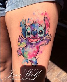 the tattoo is painted with watercolors and features an image of stitcher from stitch