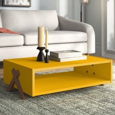 a living room with a yellow coffee table