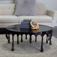 a living room with a couch, coffee table and pillows on the carpeted floor