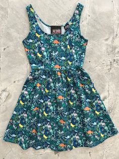 a flat lay of the front of the dino shorter length fit and flare dress Quirky Dress, Mod Clothing, Dino Print, Rockabilly Style, Amelia Dress, Dress Retro, Vintage Inspired Dresses, Retro Dress, Fit Flare Dress