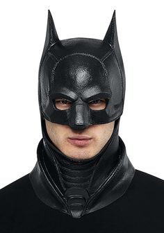 a man wearing a batman mask and black leather outfit