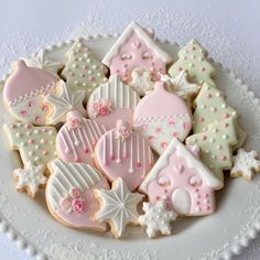 a white plate topped with lots of decorated cookies