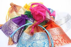 Pretty Organza Jewelry bags, You want to stand out from the crowd give your customers your jewelry pieces in these gorgeous colorful pouches. Not your typical Organza bags, these have a lovely bottom brocade trim. They come in a pack of 100 assorted colors each prettier then the other. They are well made so your customer can keep them to store the item they bought. Each pouch measures 4x4 inches and has a satin cord drawstring. I have other pouches I can source as well , so if you have something Festival Party Gift Bag Pouch, Festive Party Gift Bag Pouch, Elegant Festival Gift Bags, Elegant Festival Bags For Gifts, Elegant Festival Bags Suitable For Gifts, Elegant Multicolor Pouch For Festivals, Gold Gift Bag Pouch For Celebration, Gold Celebration Gift Bag Pouch, Traditional Multicolor Bags For Celebrations