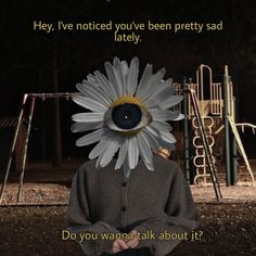 a person with a flower on their head in front of a playground and swingset