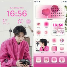 a man in pink shirt holding a cellphone next to a poster with hearts on it