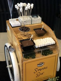 an ice cream cart with marshmallows and chocolate