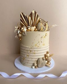 a white cake with gold decorations on top