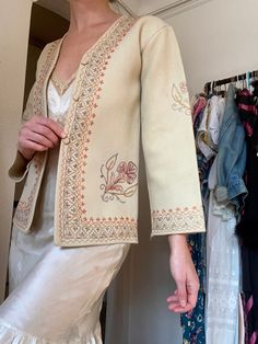 Gorgeous vintage 1940s hand embroidered floral jacket. In good condition with some flaws throughout. Some wear on the material. The embroidery in all perfect, but there is a small tear on the left shoulder seam. The button hooks are also missing. The sleeves are slightly flared. Fits best a petite/XS. Narrow in the shoulders. The wool material is very light and there is no lining. Please see measurements below! 18" width  16" across shoulders 24" length All items sold as is. I don't accept returns or refunds. I only ship for free within the US. Thank you! Vintage Long Sleeve Outerwear With Floral Embroidery, Vintage Hand-stitched Outerwear For Fall, Vintage Hand-stitched Long Sleeve Outerwear, Vintage Cream Outerwear With Floral Embroidery, Vintage Embroidered Beige Outerwear, Vintage Beige Embroidered Outerwear, Vintage Floral Embroidery Outerwear For Fall, Vintage Floral Embroidered Outerwear For Fall, Vintage Beige Outerwear With Floral Embroidery