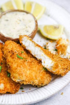 a plate with some fried fish and dipping sauce on it