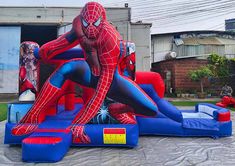 an inflatable spiderman bounce house with slide