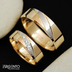 two gold wedding bands with diamonds on them