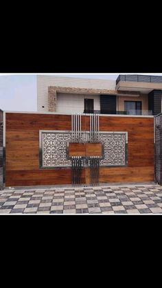 a wooden fence with an iron gate in front of it and a black and white checkered floor