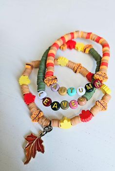 multicolored beaded bracelets with leaves and charms