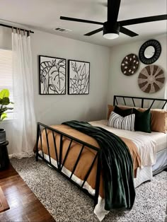 a bed room with a neatly made bed and two pictures on the wall above it