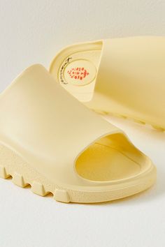 A pre- and post-workout essential, these sporty slides are featured in a smooth fabrication and slip-on style with a dreamy, cushioned insole, a single wide strap, and bold traction details perfect for taking you from the studio to the street. * Buti logo detailing * Flat-sole style * Lightweight design **Sizing:** * S: EU 35/36, US 5/6 * M: EU 37/38, US 7/8 * L: EU 39/40, US 9/10 * XL: EU 41/42, US 11/12 **Fit:** This style runs true to size; if in between sizes, we suggest sizing up. **About T Spring Foam Slides With Non-slip Details, Spring Foam Slides With Non-slip Design, Spring Foam Slip-on Slides, Spring Non-slip Foam Slides, Foam Slide Sandals With Rubber Sole, Foam Slides With Rubber Sole, Comfortable Solid Color Slides With Rubber Sole, Summer Slides With Rubber Sole And Foam, Foam Slides With Textured Footbed