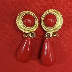 Vintage Red Tear Drop Clip Earrings Gold Tone Measurements: 0.75 x 0.5 x 1.75 in Features: * Clip Earrings Condition: Pre-Owned Good Red Clip-on Dangle Jewelry, Red Clip-on Earrings For Formal Occasions, Red Formal Costume Jewelry Earrings, Red Costume Jewelry Earrings For Formal Occasions, Vintage Red Drop Clip-on Earrings, Red Vintage Style Drop Clip-on Earrings, Red Clip-on Round Jewelry, Red Round Clip-on Jewelry, Red Dangle Clip-on Earrings For Formal Occasions