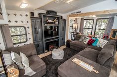 a living room filled with furniture and lots of windows