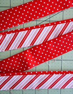 three red and white striped ties laying next to each other on top of a table