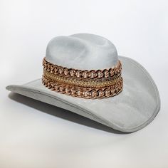 Handmade cowboy hat made with high quality fabrics and trims. ETA can take up to 14 days to delivered due to the fact that each pieces are handmade Has multi chains around the hat Gold Western Hat Band For Kentucky Derby, Western Gold Hat Bands For Kentucky Derby, Western Gold Hat Band For Rodeo, Gold Western Hat Band For Western-themed Events, Gold Western-style Hat Band For Western-themed Events, Gold Western Hat For Country Events, Gold Country Style Hat For Rodeo, Country-style Gold Hat For Rodeo, Gold Country Style Hat Bands For Country Events