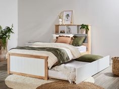 a bed sitting in a bedroom on top of a wooden floor next to a rug