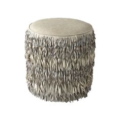 a round ottoman covered in feathers on a white background