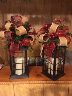 two lanterns with christmas decorations on them