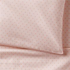 a bed with pink and orange stars on it