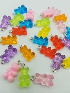 many different colored gummy bears are on a white surface