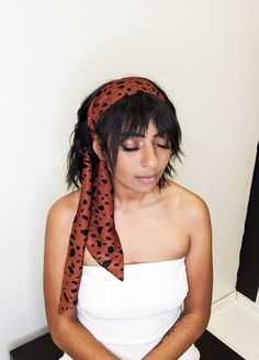 "Multi use soft scarf that can be wrapped around your head as a hairband, used as a neck scarf or a belt. To wear as a hair wrap just cross over the front and tie behind your head. It's very lightweight and instantly adds style to your outfit, coming in handy on bad hair days or vacation days. Lovely neutral print featuring black spots on brown with a satin finish. Material: poly satin Print: spots Measurements: 3\" - 4\" by 58\" Care: delicate hand wash, line dry. Snakeskin hair scarf available Bandana As A Belt, Satin Hair Scarf, Knot Hairband, Printed Bandana, Neutral Print, Tulle Bows, Vacation Days, Soft Scarf, Neutral Prints